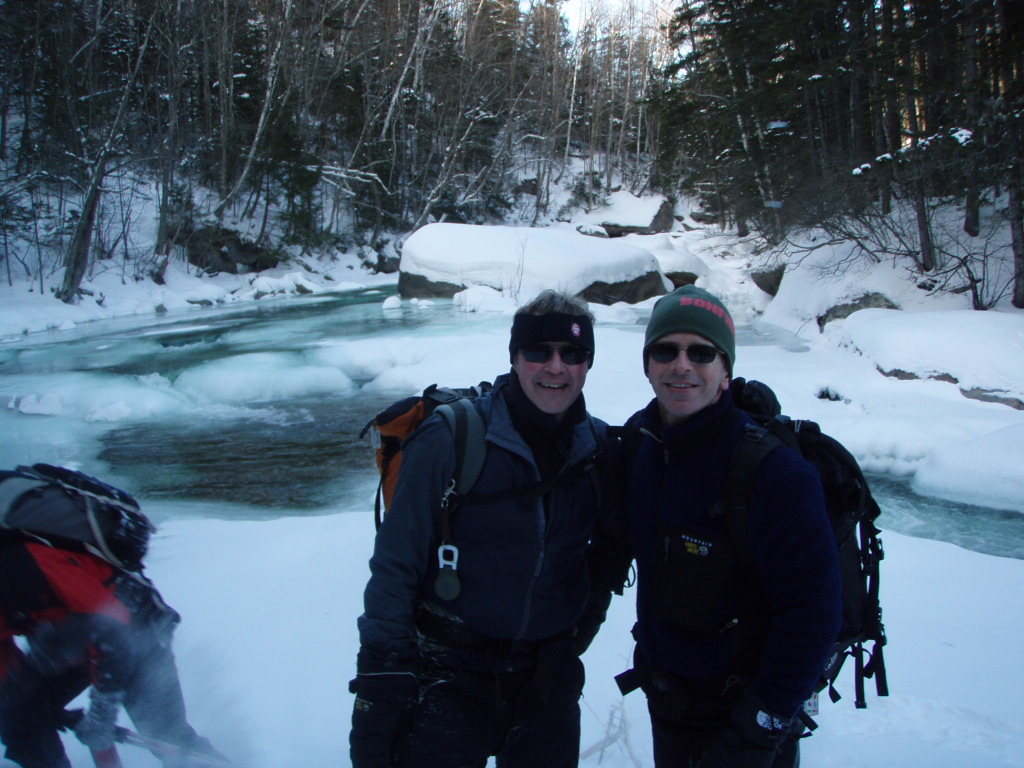 Two GayOutdoors members by a frozen stream in winter